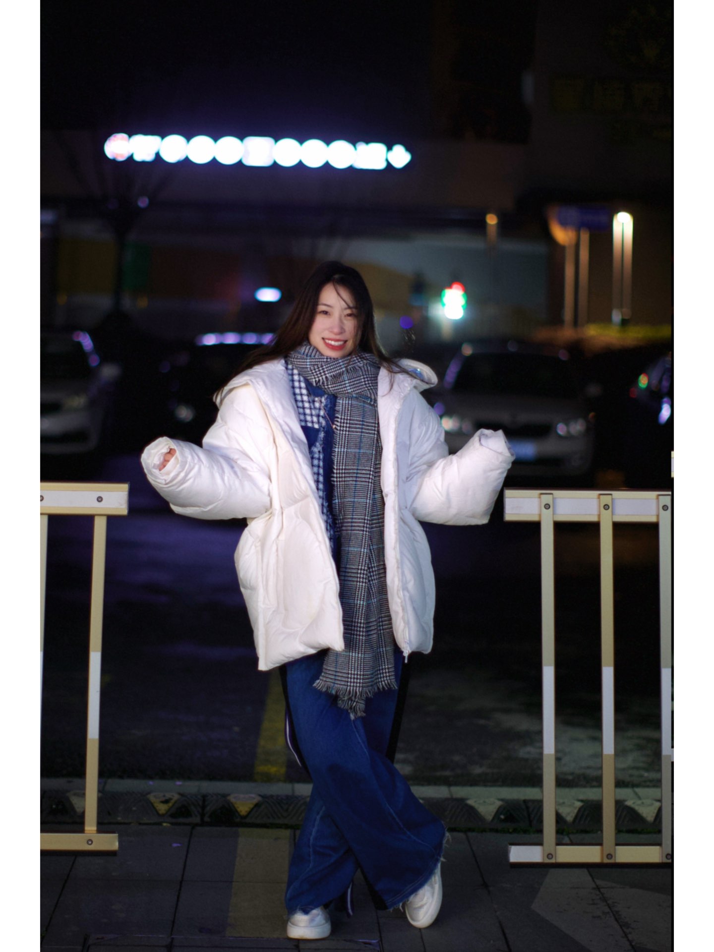 寒冷夜里橘色路灯下在路边哈气的小女孩儿