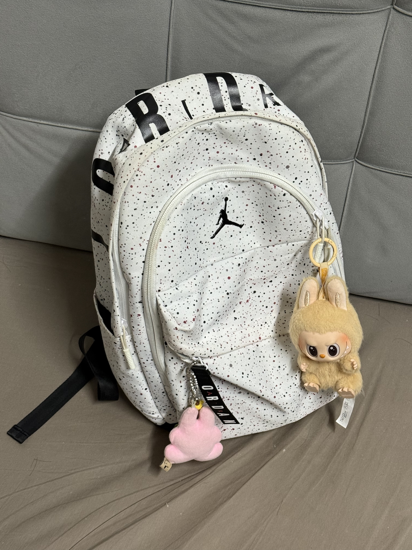 就是这个aj满天星书包哇
书包是纯白底色 满天星反光 
质感蛮好的的aj