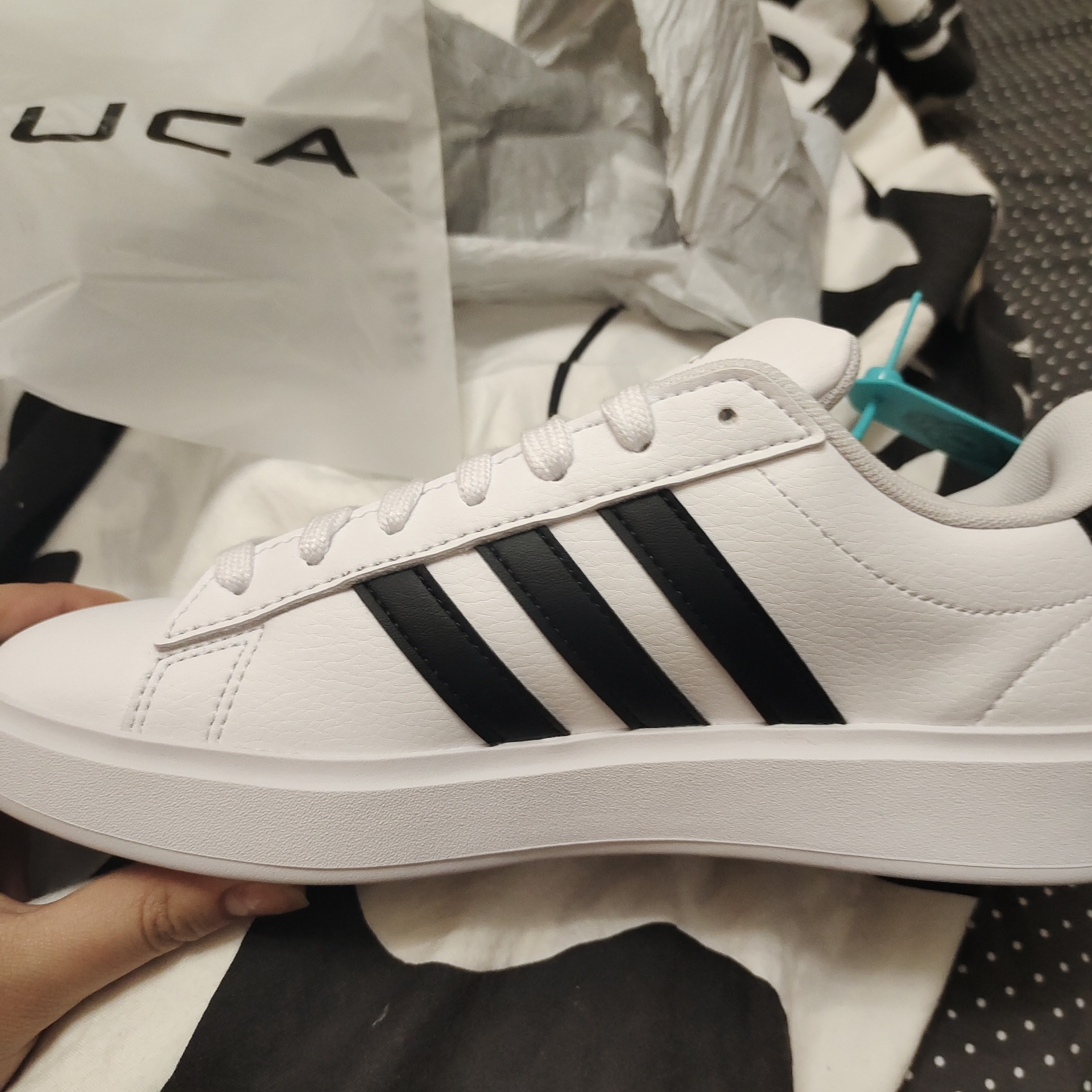 white adidas with black stripes on one side