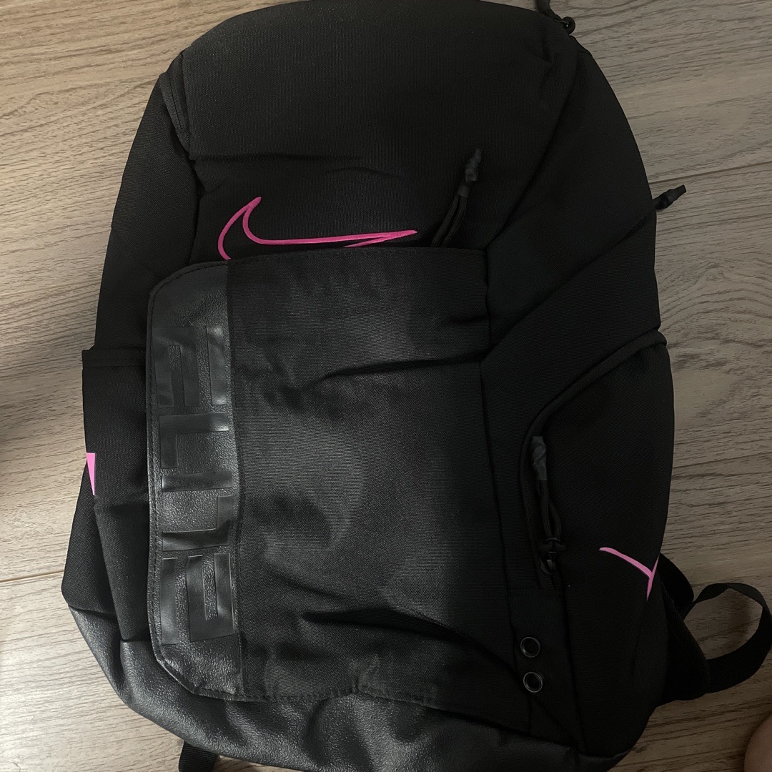 black nike bag with pink tick